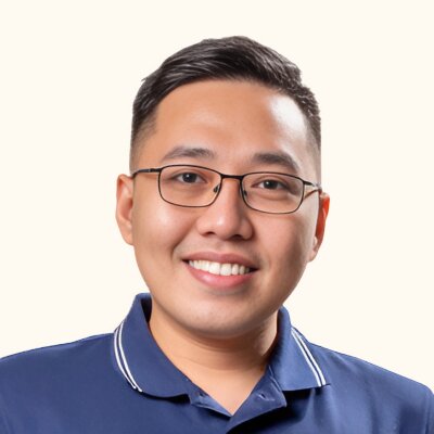 Kenny Clerigo, smiling, wearing glasses and a navy polo shirt.